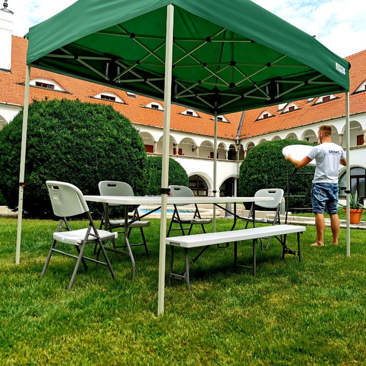 Green party tent 2x2 with seating (table and chairs)