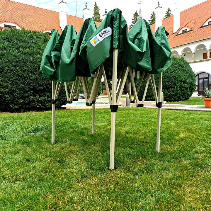Green tarp folded on a scissor structure before unfolding