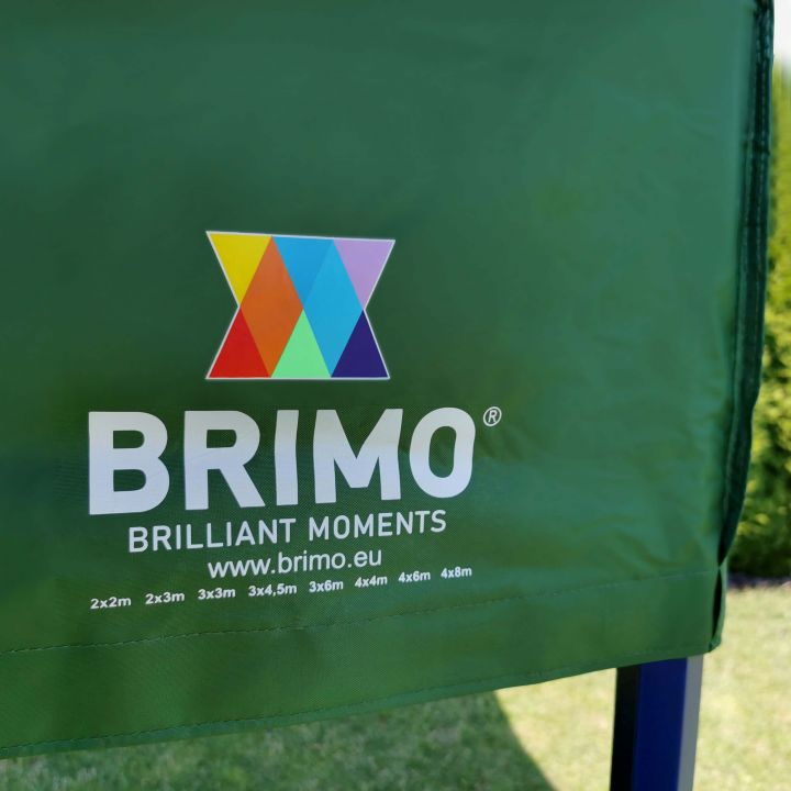 Detail of the green fabric (roof/sides) of the tent with the white "BRIMO" logo and colorful triangles.