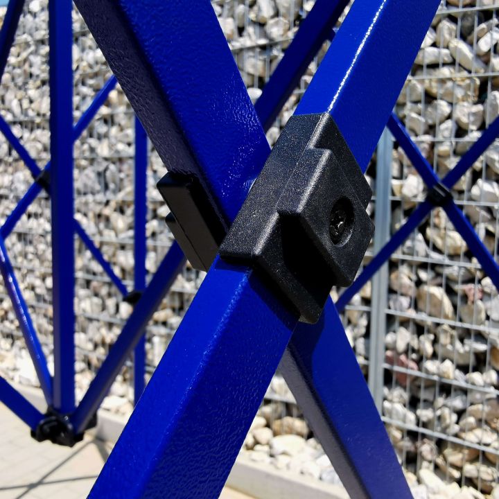 Detail of the black plastic connector part on the blue metal structure (rods) of the scissor tent.